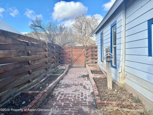 a front view of house with wooden fence