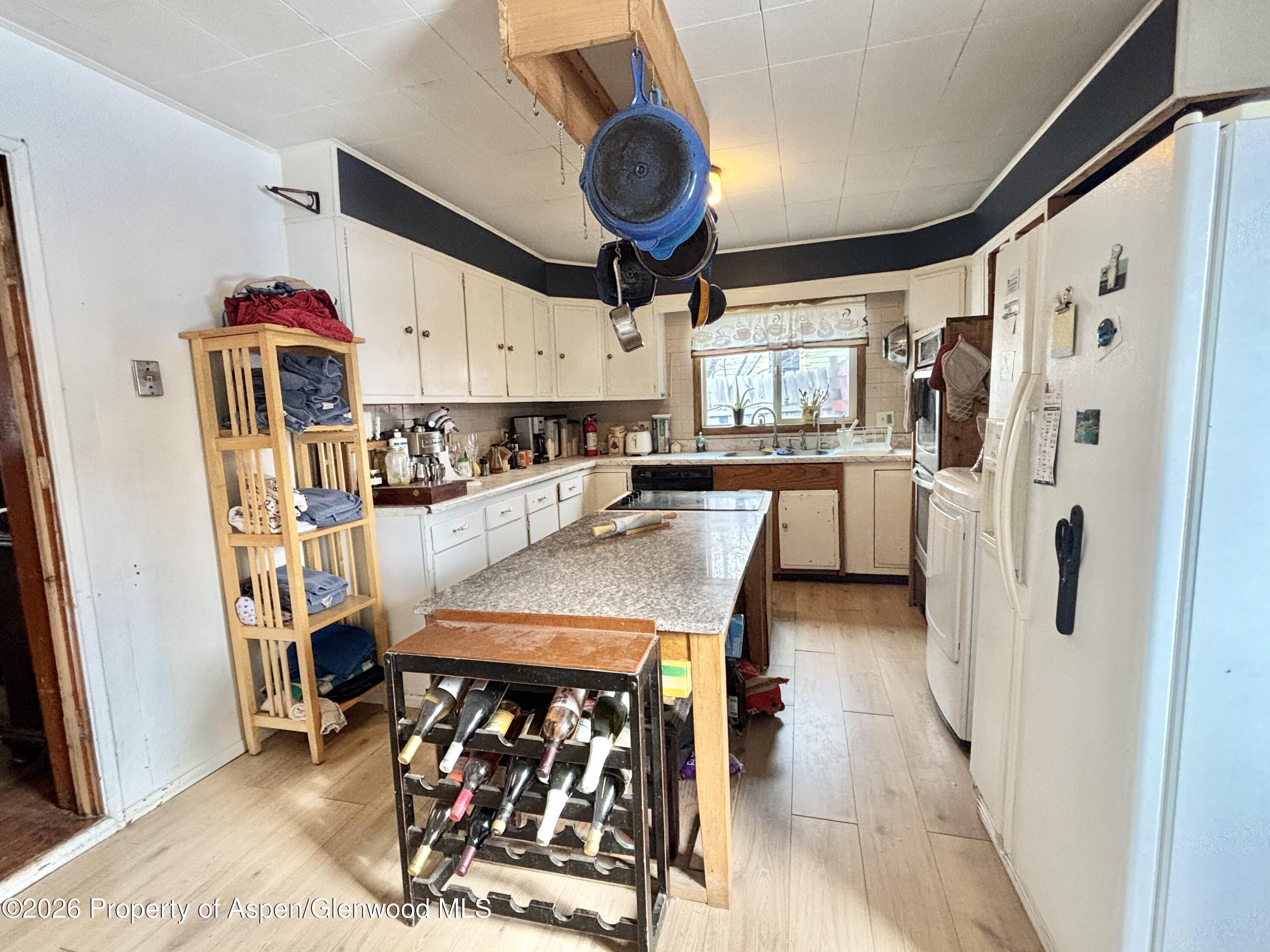 744 Market Street Meeker, CO 81641 - Photo 2 of 17 a view of a dining area with furniture window and wooden floor