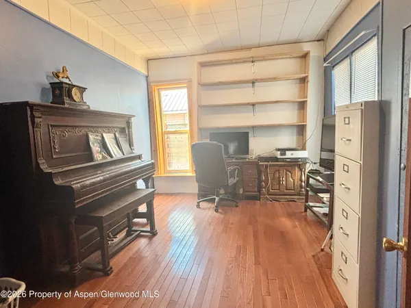 a bedroom with a bed and a flat tv screen