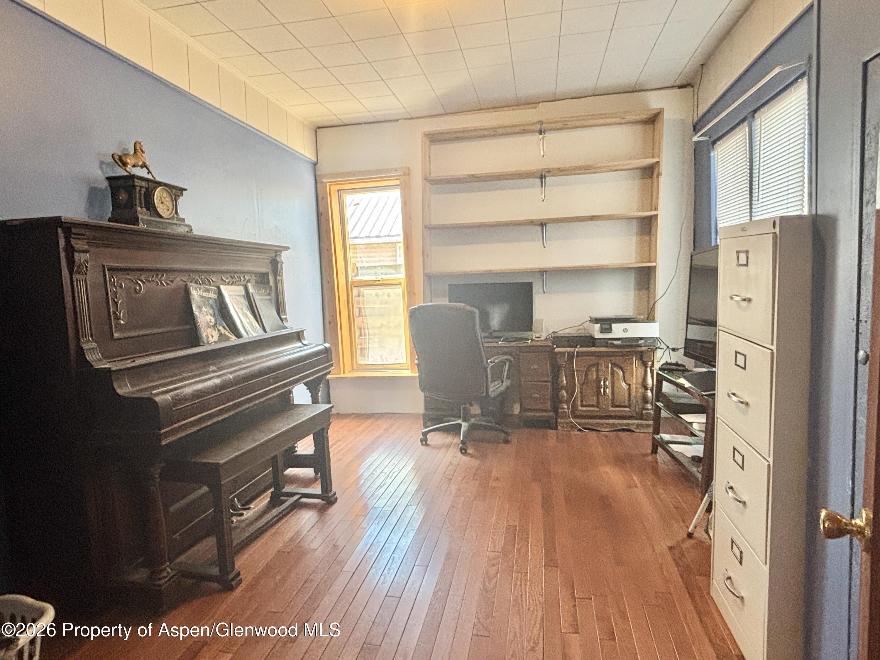 744 Market Street Meeker, CO 81641 - Photo 8 of 17 a view of a workspace with furniture and wooden floor