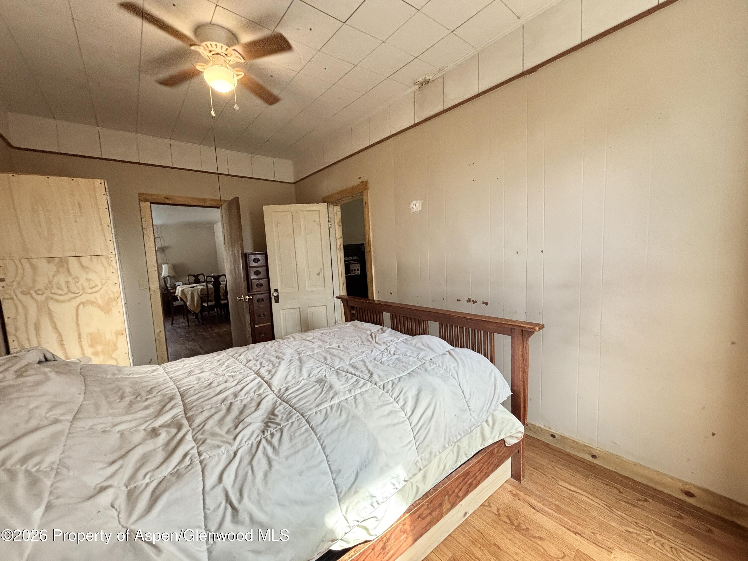 744 Market Street Meeker, CO 81641 - Photo 10 of 20 a bedroom with a bed and a chandelier