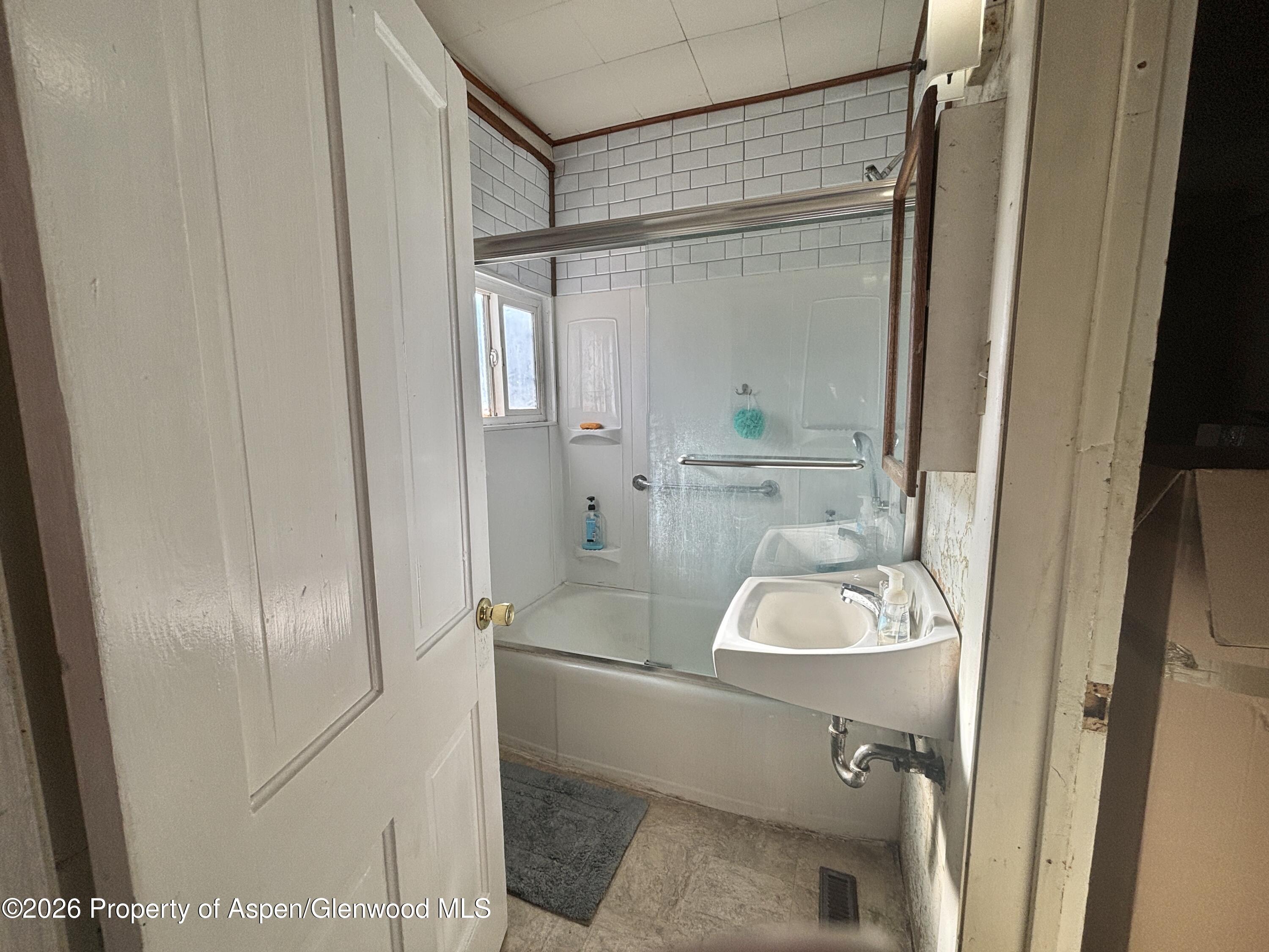 744 Market Street Meeker, CO 81641 - Photo 10 of 17 a bathroom with a sink and shower