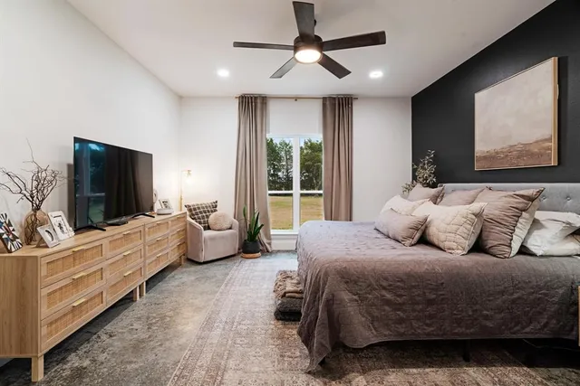 a bedroom with a bed and a flat screen tv