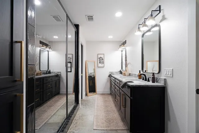 a bathroom with a sink vanity and a mirror