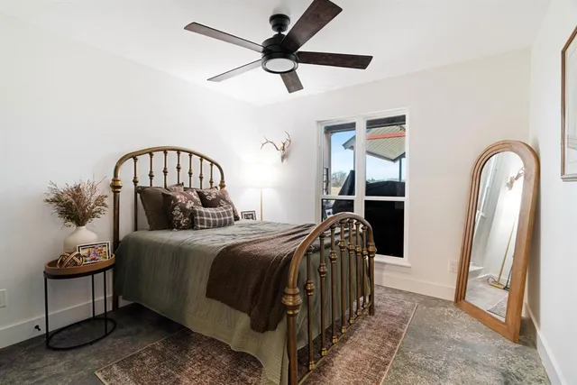 a bedroom with a bed a mirror and a table