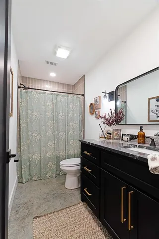 a bathroom with a sink toilet a mirror and shower