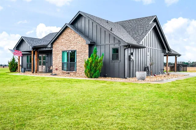a view of a house with a yard and porch
