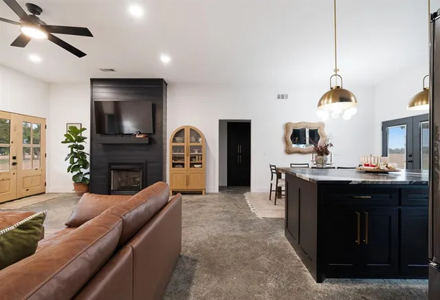 a living room with fireplace furniture and a flat screen tv