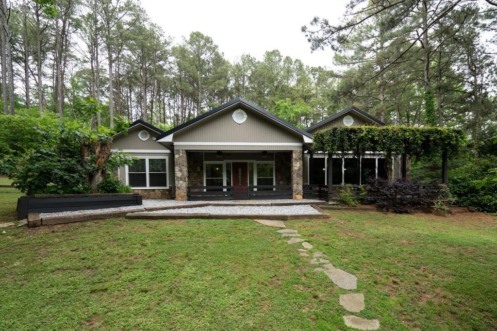 a front view of a house with a garden and porch