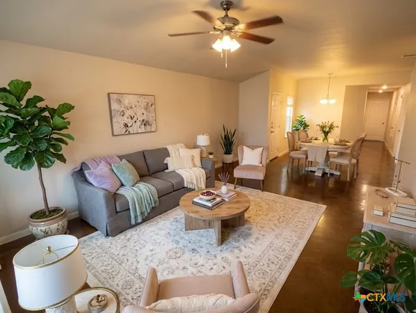 a living room with furniture and a potted plant