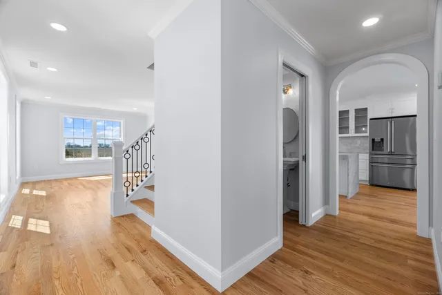a view of a kitchen with wooden floor and a window