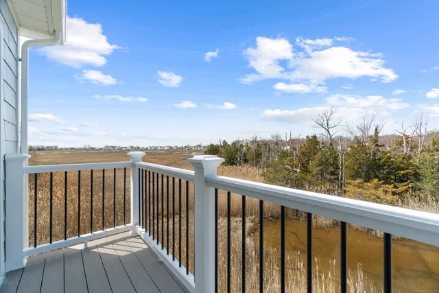 a balcony with wooden floor and city view