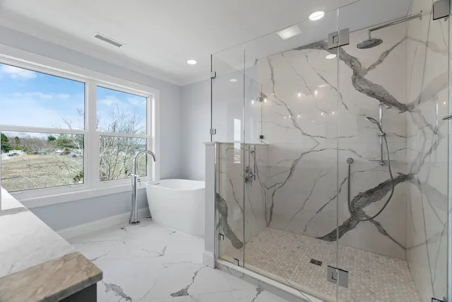 a bathroom with a bathtub and a shower