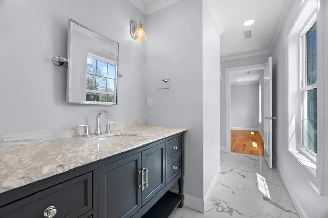 a bathroom with a granite countertop sink and a mirror