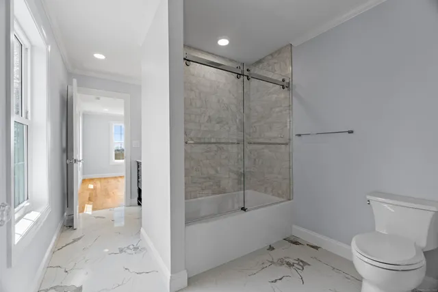 a bathroom with a shower a toilet and a shower