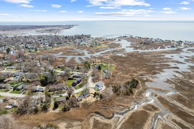 an aerial view of residential building and ocean view in back