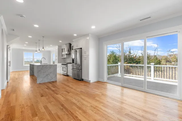 a view of kitchen with wooden floor and windows