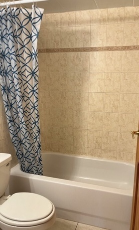 5209 South Leclaire Avenue, Unit 3B Chicago, IL 60638 - Photo 4 of 8 a bathroom with a toilet and a shower