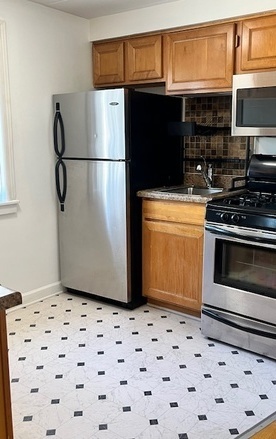 5209 South Leclaire Avenue, Unit 3B Chicago, IL 60638 - Photo 7 of 8 a refrigerator freezer sitting inside of a kitchen