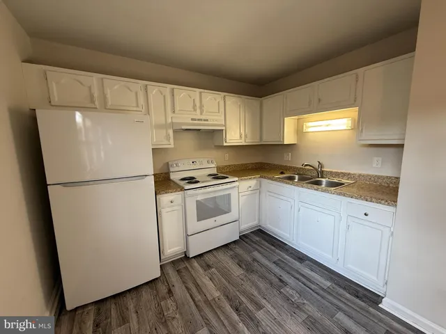 a white refrigerator freezer sitting inside of a kitchen