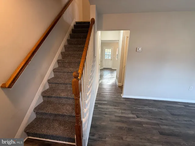 a view of an entryway with wooden floor