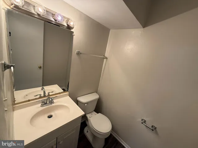 a bathroom with a sink mirror toilet and a mirror