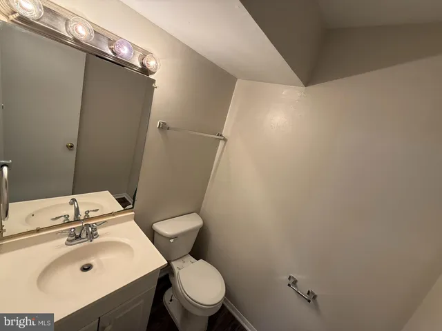 a bathroom with a sink toilet and mirror
