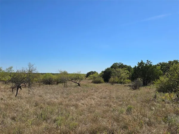 a view of ocean beach and mountain