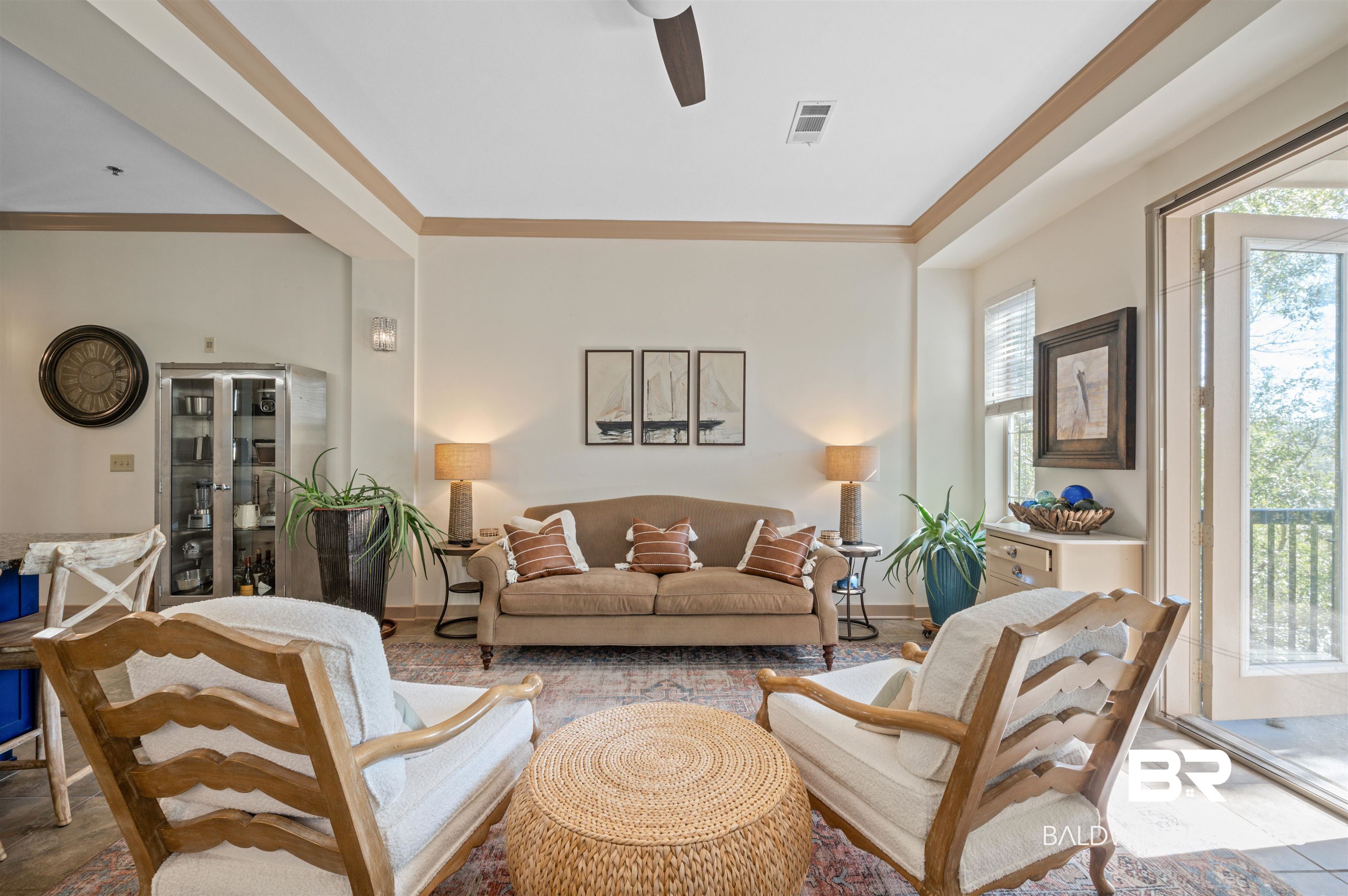 1430 Regency Road, Unit B202 Gulf Shores, AL 36542 - Photo 1 of 33 Living area featuring ornamental molding, a ceiling fan, visible vents, and baseboards