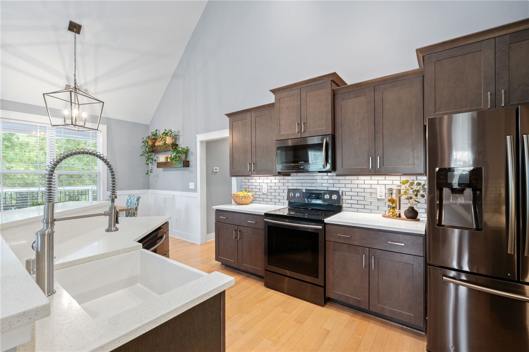1050 Old Dacusville Road Easley, SC 29640 - Photo 11 of 33 This bright kitchen features vaulted ceilings and modern appliances, creating an inviting space for culinary endeavors.