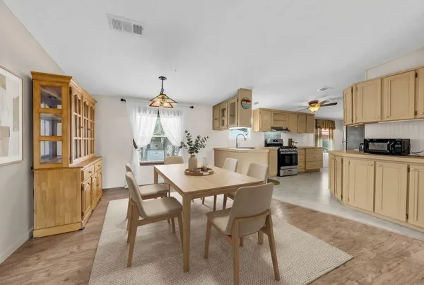 a view of a dining room with furniture and wooden floor