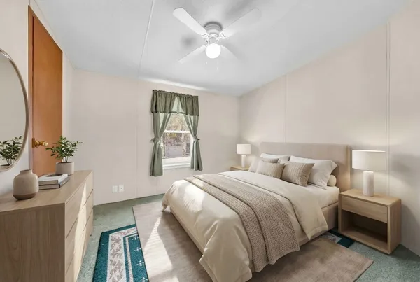 a bedroom with a bed and a potted plant