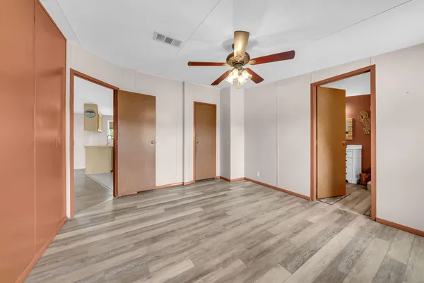 a view of a room with a ceiling fan and a ceiling fan