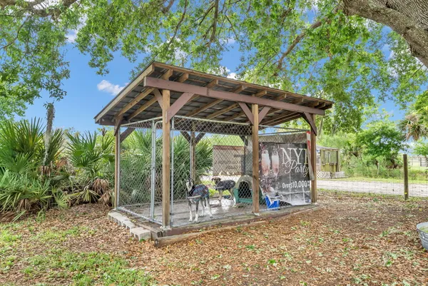 a view of a patio with a table and chairs under an umbrella