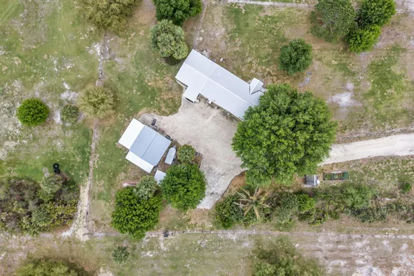 an aerial view of a house with yard