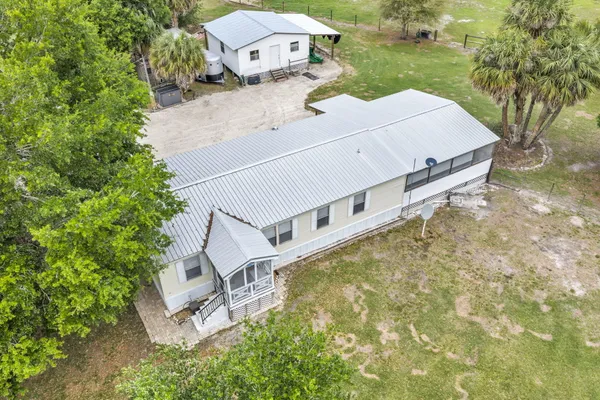 an aerial view of a house with backyard