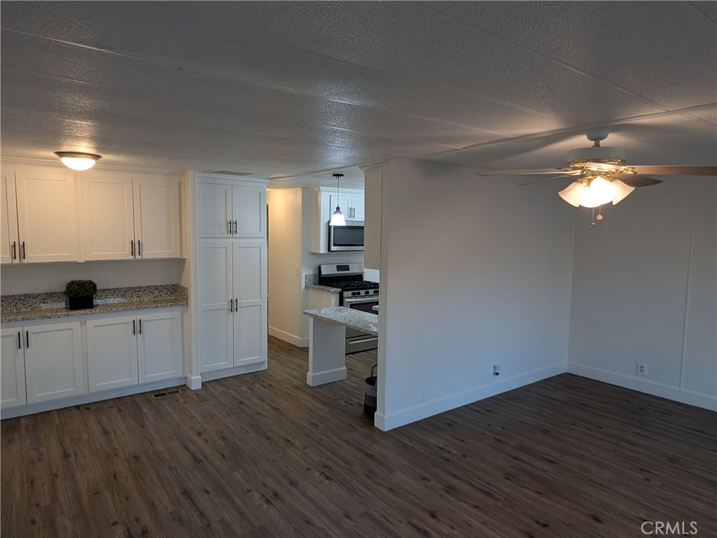 881 North Lake Street, Unit 357 Hemet, CA 92544 - Photo 11 of 29 a kitchen with a sink and cabinets
