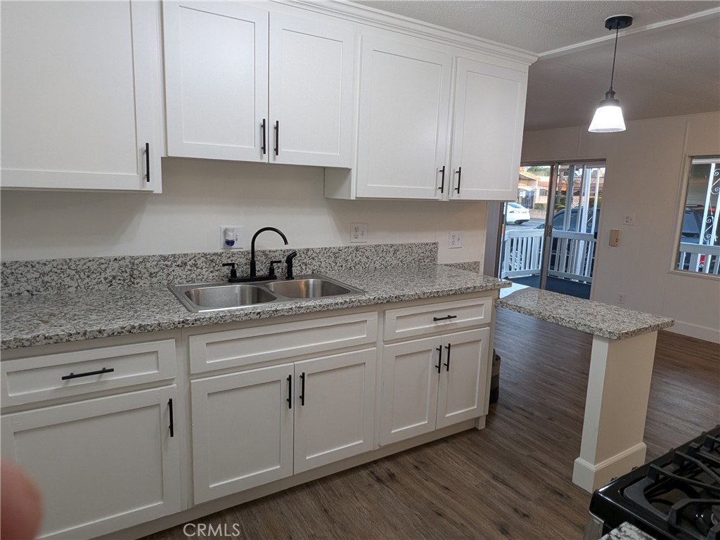 881 North Lake Street, Unit 357 Hemet, CA 92544 - Photo 12 of 29 a kitchen with granite countertop white cabinets white appliances and sink