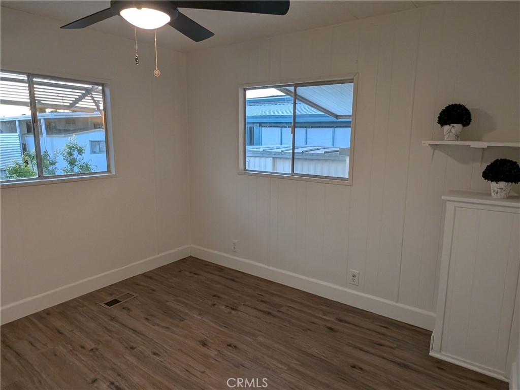 881 North Lake Street, Unit 357 Hemet, CA 92544 - Photo 17 of 29 a view of an empty room with wooden floor and a window