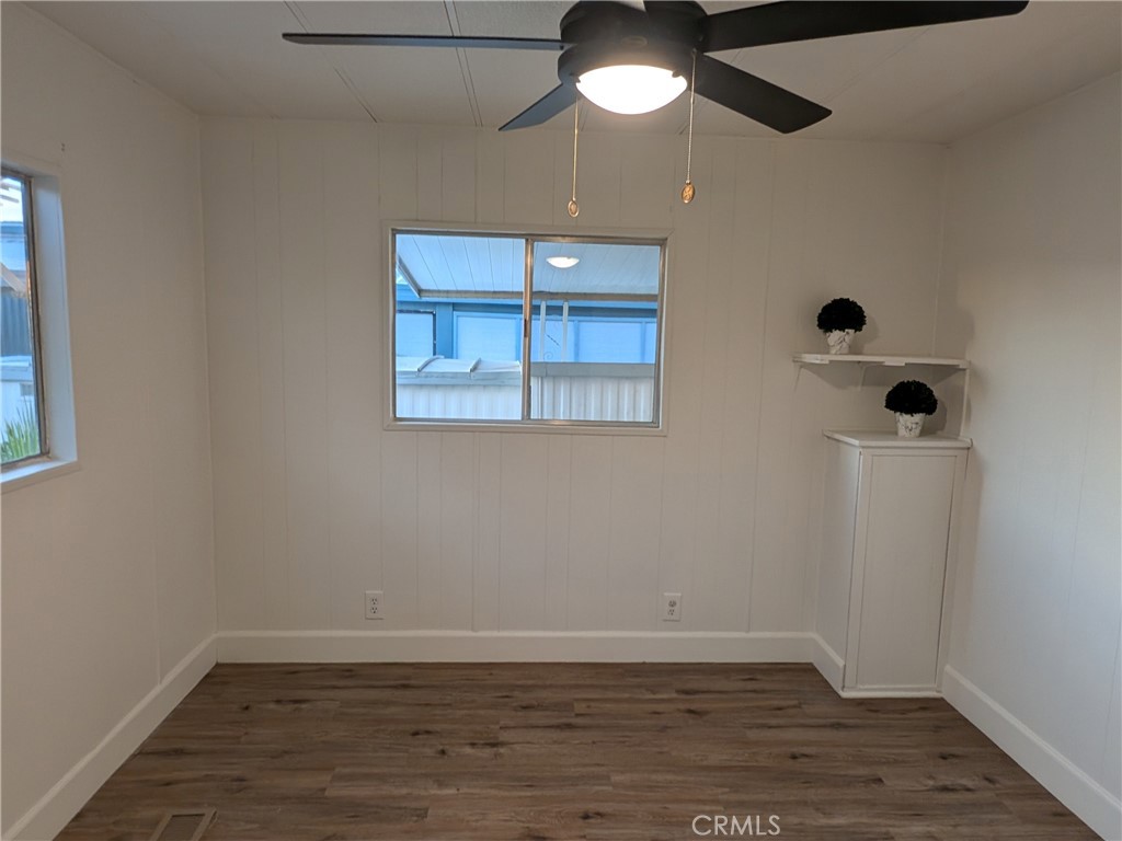 881 North Lake Street, Unit 357 Hemet, CA 92544 - Photo 18 of 29 a view of an empty room with wooden floor and a window