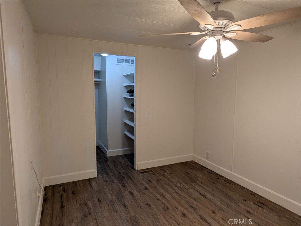 881 North Lake Street, Unit 357 Hemet, CA 92544 - Photo 21 of 29 an empty room with wooden floor fan and windows