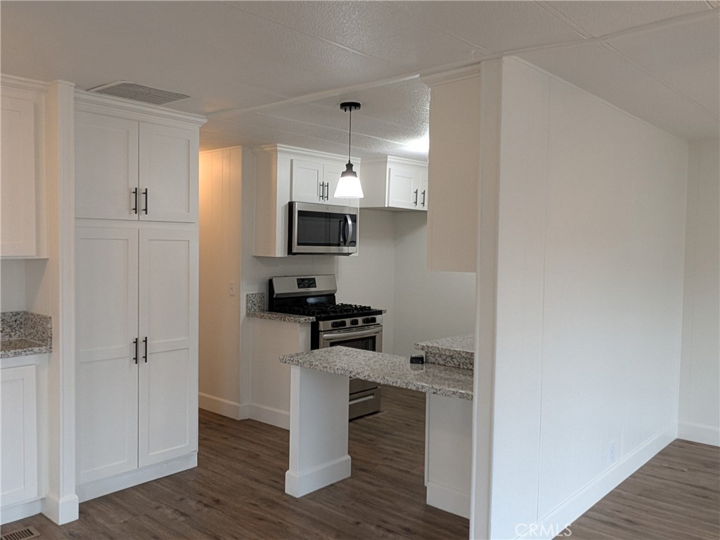 881 North Lake Street, Unit 357 Hemet, CA 92544 - Photo 7 of 29 a kitchen with a sink appliances and cabinets