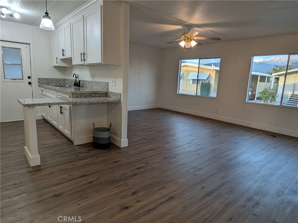 881 North Lake Street, Unit 357 Hemet, CA 92544 - Photo 8 of 29 a kitchen with stainless steel appliances granite countertop a stove a sink and a wooden floors