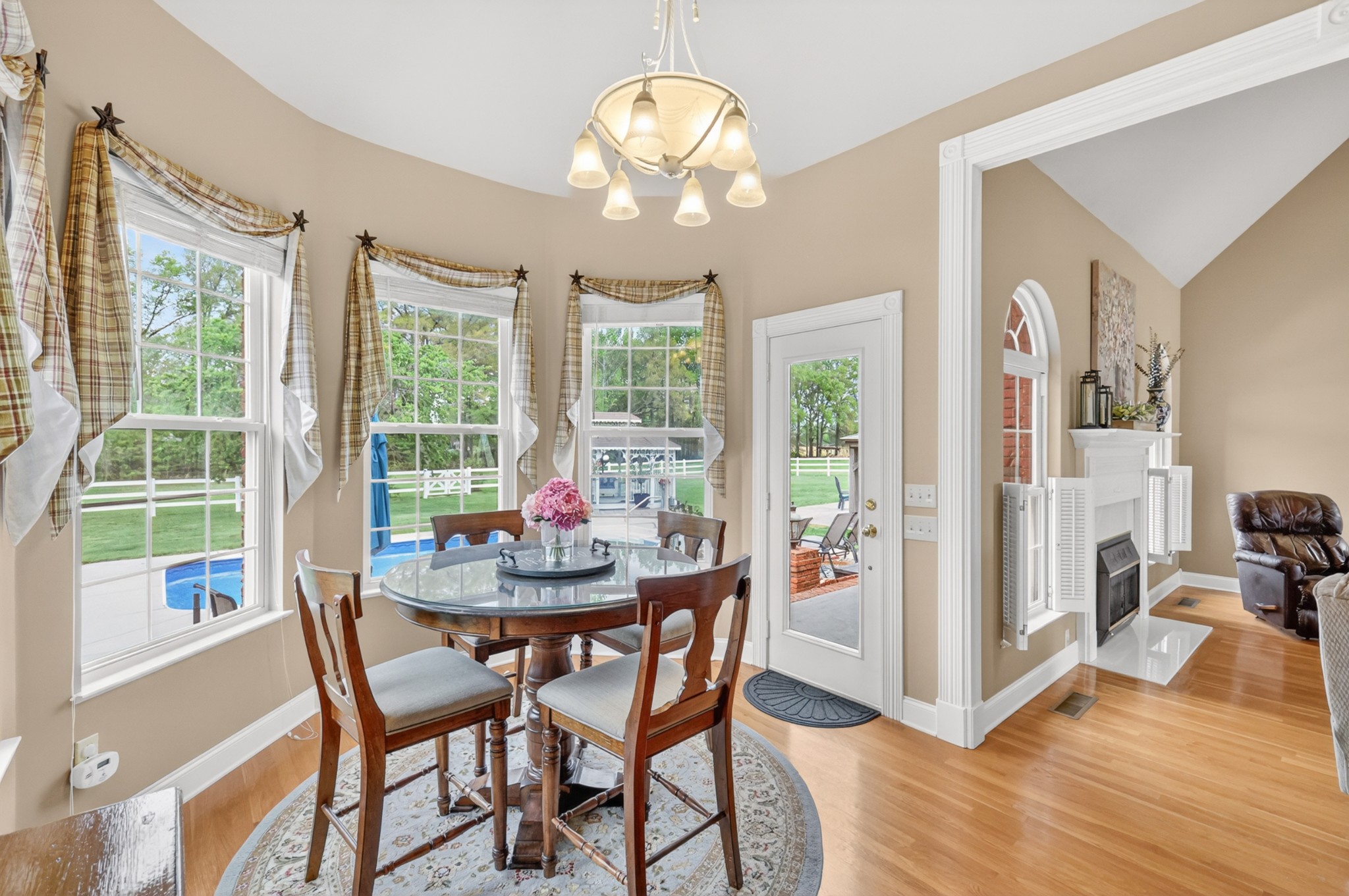 2015 Spry Road Bradyville, TN 37026 - Photo 15 of 77 a dining room with wooden floor a chandelier a glass table and chairs