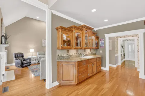 a kitchen with stainless steel appliances granite countertop a stove and a kitchen island with large windows