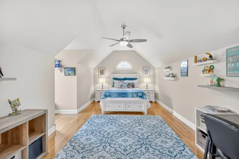 a view of a swimming pool and lounge chairs in back yard of the house
