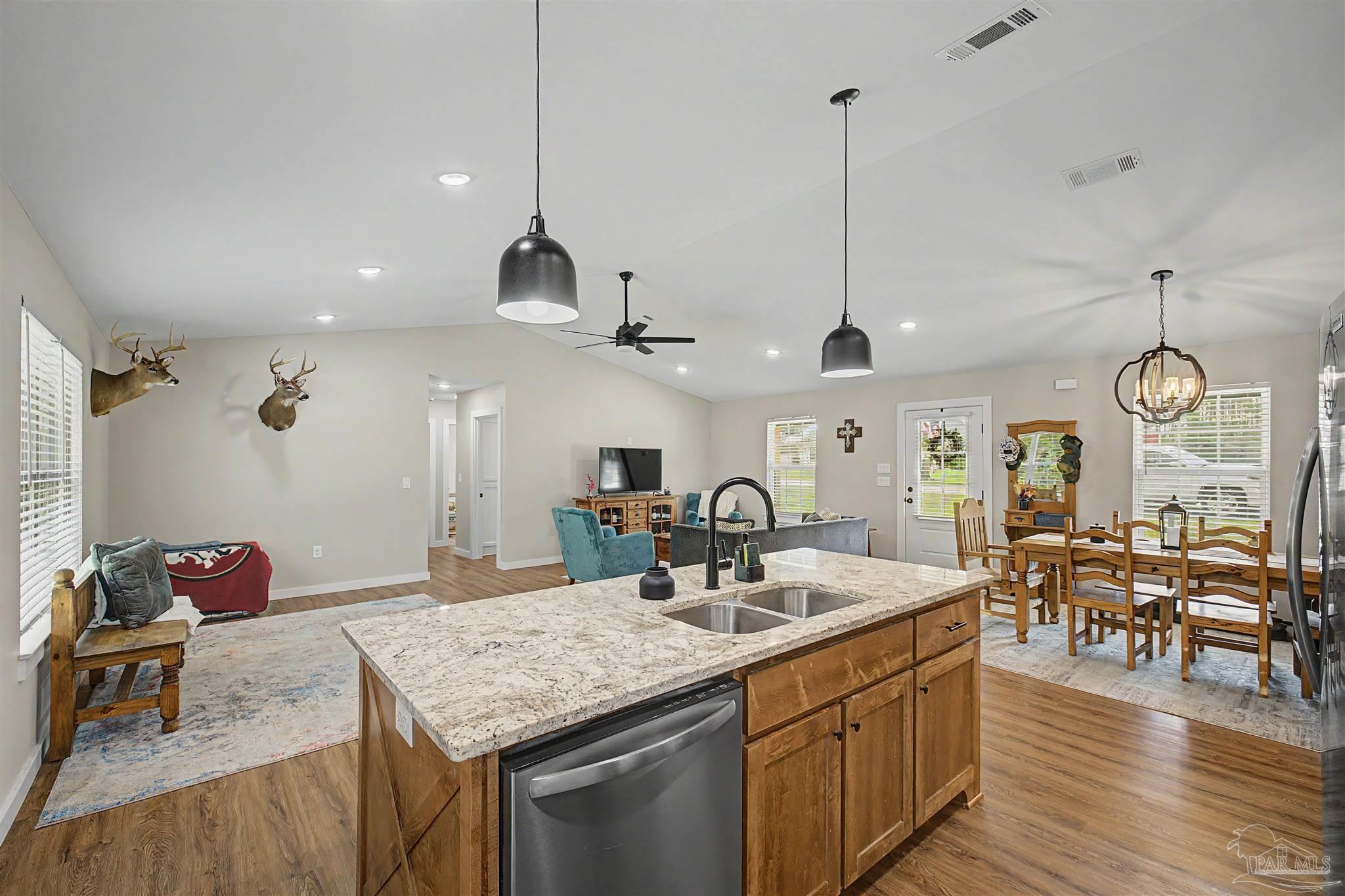 2549 Ten Mile Road Pace, FL 32571 - Photo 5 of 46 a kitchen with center island table and chairs in it
