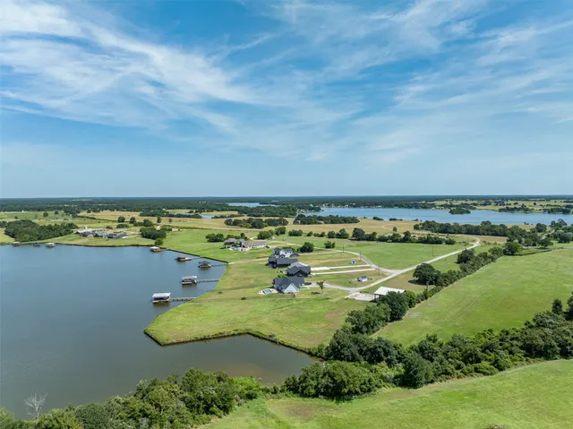 an aerial view of ocean with residential houses with outdoor space