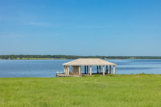 a view of a field with an ocean view
