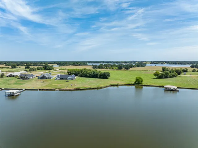 an aerial view of a houses with a lake view